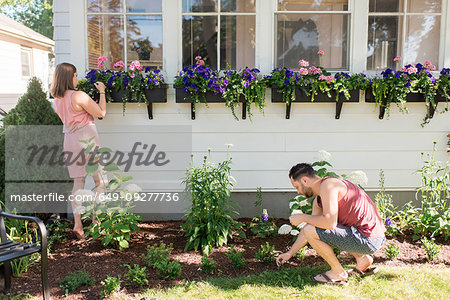 Couple gardening in front porch