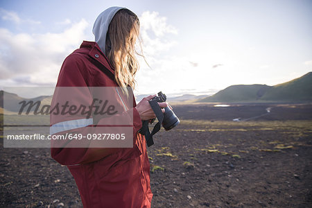 Hiker looking at camera, Landmannalaugar, Highlands, Iceland