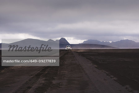 Off road vehicle on dirt track heading to hills, Landmannalaugar, Iceland