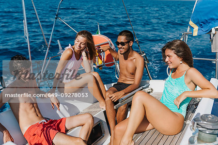 Friends relaxing on sailboat, Italy