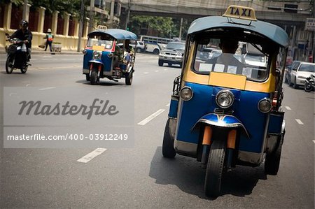 Tuk-tuk (cab) speeding on the street. Picture taken in Bangkok / Thailand
