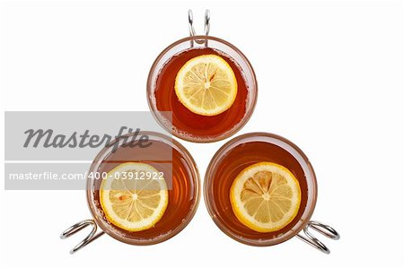 Three glass cups of tea with one slice of lemon. Shallow dof