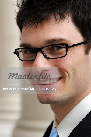 Close-up of a young corporate male worker smiling.