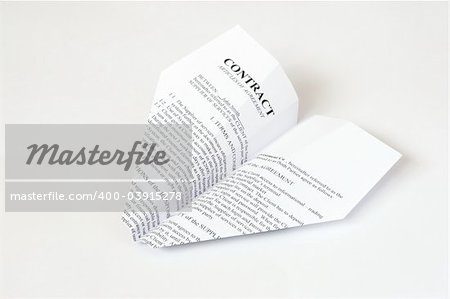white paper airplane with contract text on it