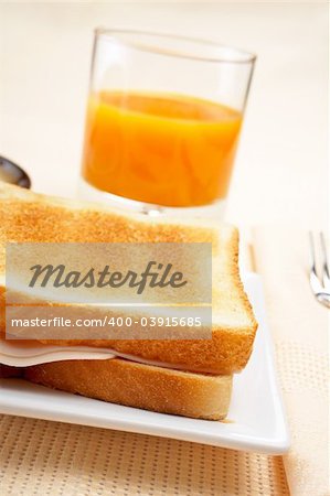 Sandwich, cup of coffee and fresh squeezed orange juice for breakfast. Shallow DOF