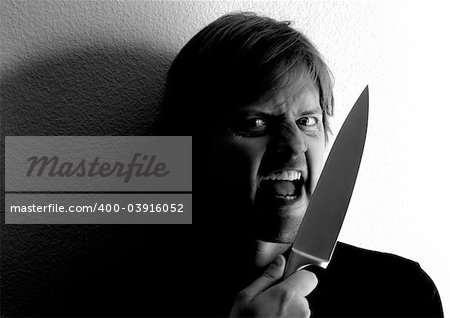 Crazy fellow wielding a knife.  Harsh lighting and shadows for more dramatic effect.