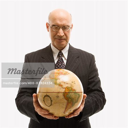 Caucasian middle-aged businessman holding globe in both hands standing in front of white background.