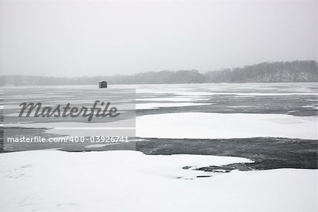 Scenic of frozen lake with ice fishing shack in Green Lake, Minnesota, USA.