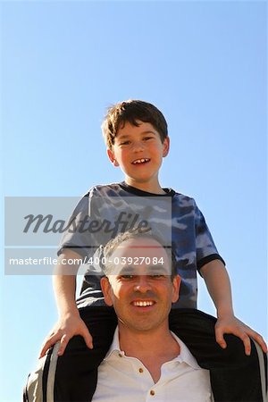 Portrait of father and son playing outdoors