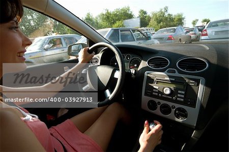 young happy woman driving a car