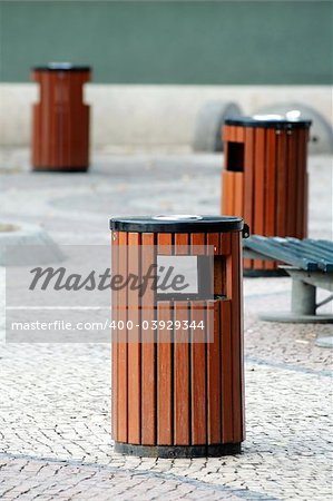 Three wooden litter bins in public area