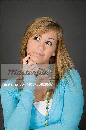 Teenage girl posing on gray background with some attitude