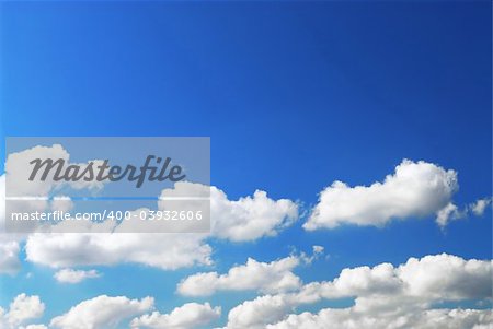 Background of deep blue sky with white fluffy clouds at the bottom