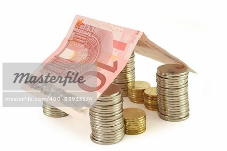House made of coins and euro banknote - real estate concept (isolated, clipping path)
