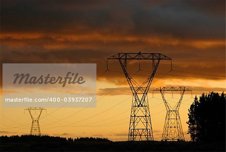 Electric towers and national power line. Dramatic sunset on the background.