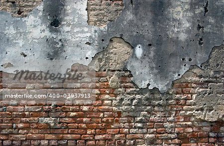 old brick wall falling apart with age and decay, usefull for background