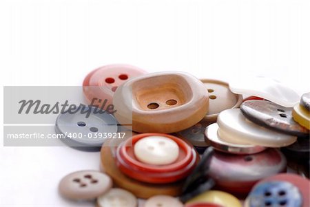 colored sewing buttons on a white background