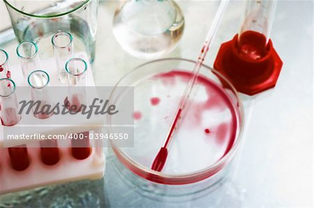 Laboratory equipment - test tubes, flasks, weighting bottles etc. Still life, close-up. Low DOF, focus is on test tubes