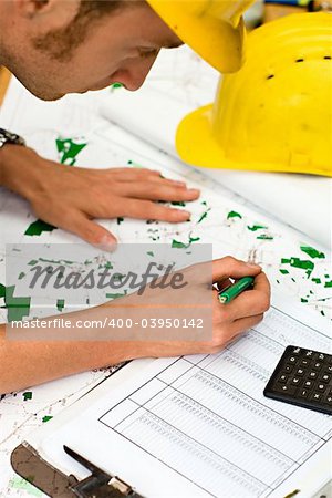 construction worker checking documents and maps