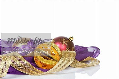 Christmas decoration with balls and candles, over white background. Shallow DOF