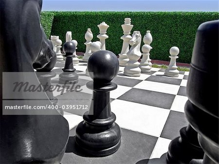 Outdoor chess board in garden with pieces