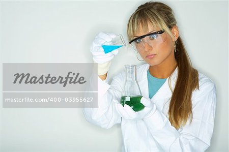 Beautiful female lab worker testing and experimenting