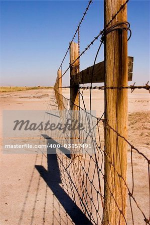 Fence in the Sale Lake in Summer in Utah with Clear Blue Skies