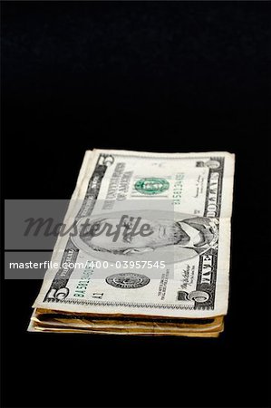 Stack of dollar bills, isolated on black background