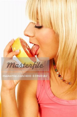 Happy beautiful women with holding and licking grapefruit