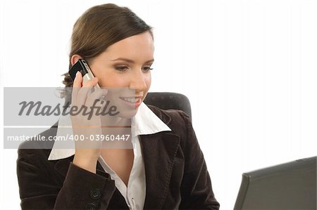 Young woman with cell phone looking at a laptop