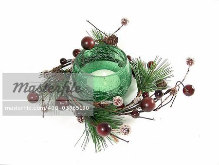 Green glass candlestick inside the garland as Christmas decoration
