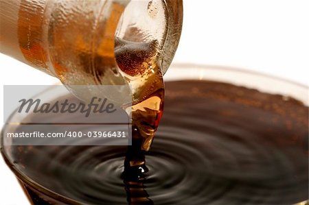 Red wine pouring down from a wine bottle