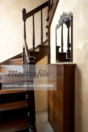 Wooden staircase and beautiful mirror in the modern house