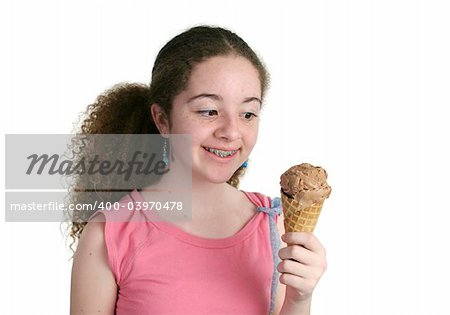 A teen girl with braces looking hungrily at an ice cream cone.