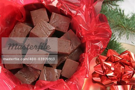 a closeup of homemade fudge in a holiday tin for gift giving