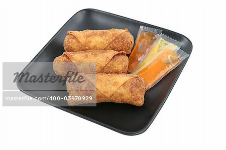 Crispy fried Chinese egg rolls with duck sauce and mustard.  Isolated with clipping path.