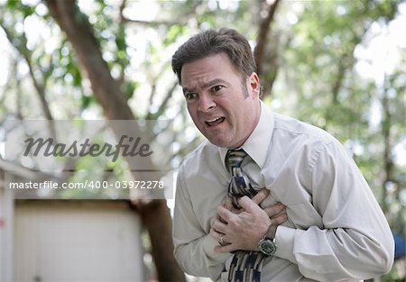 A forty year old businessman outdoors experiencing chest pain.