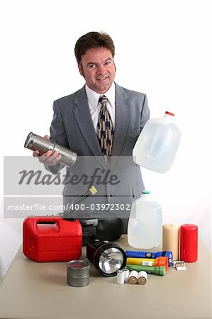 a weatherman showing a hurricane kit and holding up canned food & bottled water