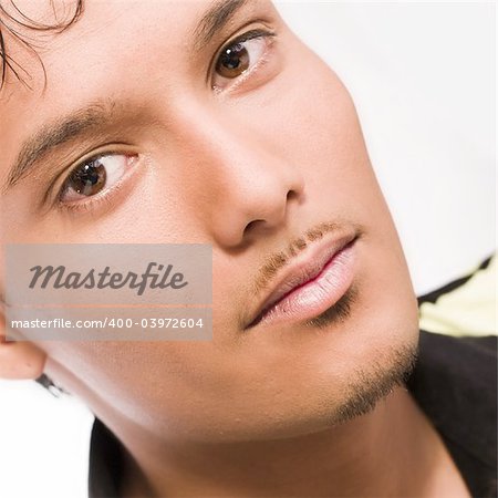 Studio portrait of mixed race young man looking concentrated