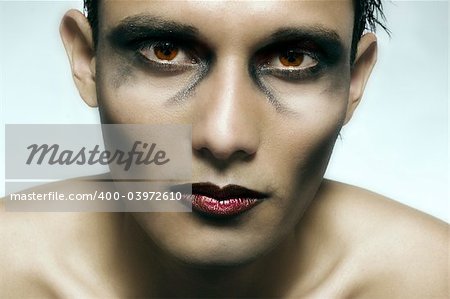 Studio portrait of mixed race young man with extreme make-up