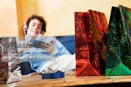 guy relaxing on the couch after shopping. The guy is blurred.