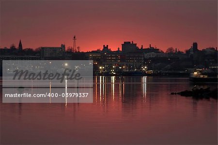 Dramatic sunset giving way to the lights of nighttime operations on the fishing boats in New Bedford harbor