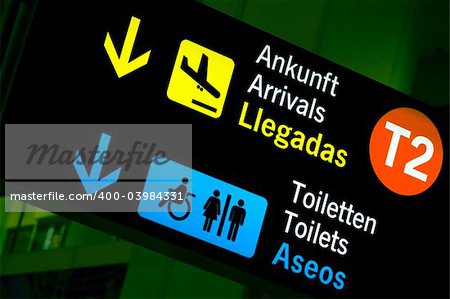 Arrivals and toilets sign panels in airport, Malaga.