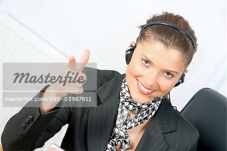 young businesswoman or customer service at work wearing headphones
