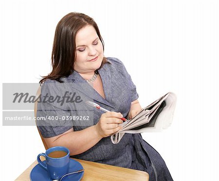 Pretty plus-sized businesswoman checking the stock market in the newspaper.  Could also be job search in classifieds.  Isolated on white.