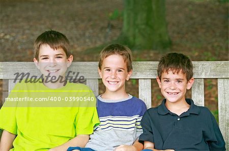 Three Kids Sitting on a Bench