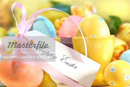 Festive decorations and eggs with card that reads Happy Easter