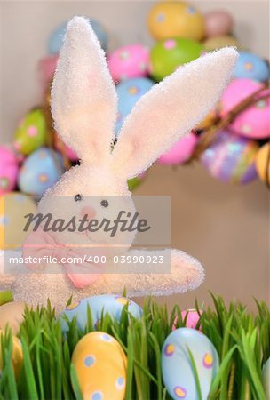 White rabbit with colored eggs for Easter