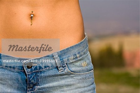 Woman abdomen in jeans detail.