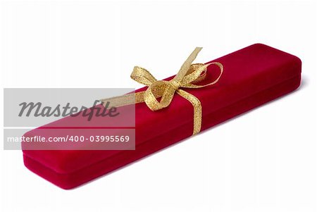 Red velvet jewelry box tied by gold ribbon